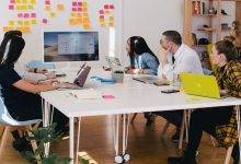 A team in an office discussing PSA software in a meeting